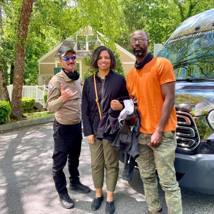 Lilián Pallares et al. standing in front of a car posing for the camera