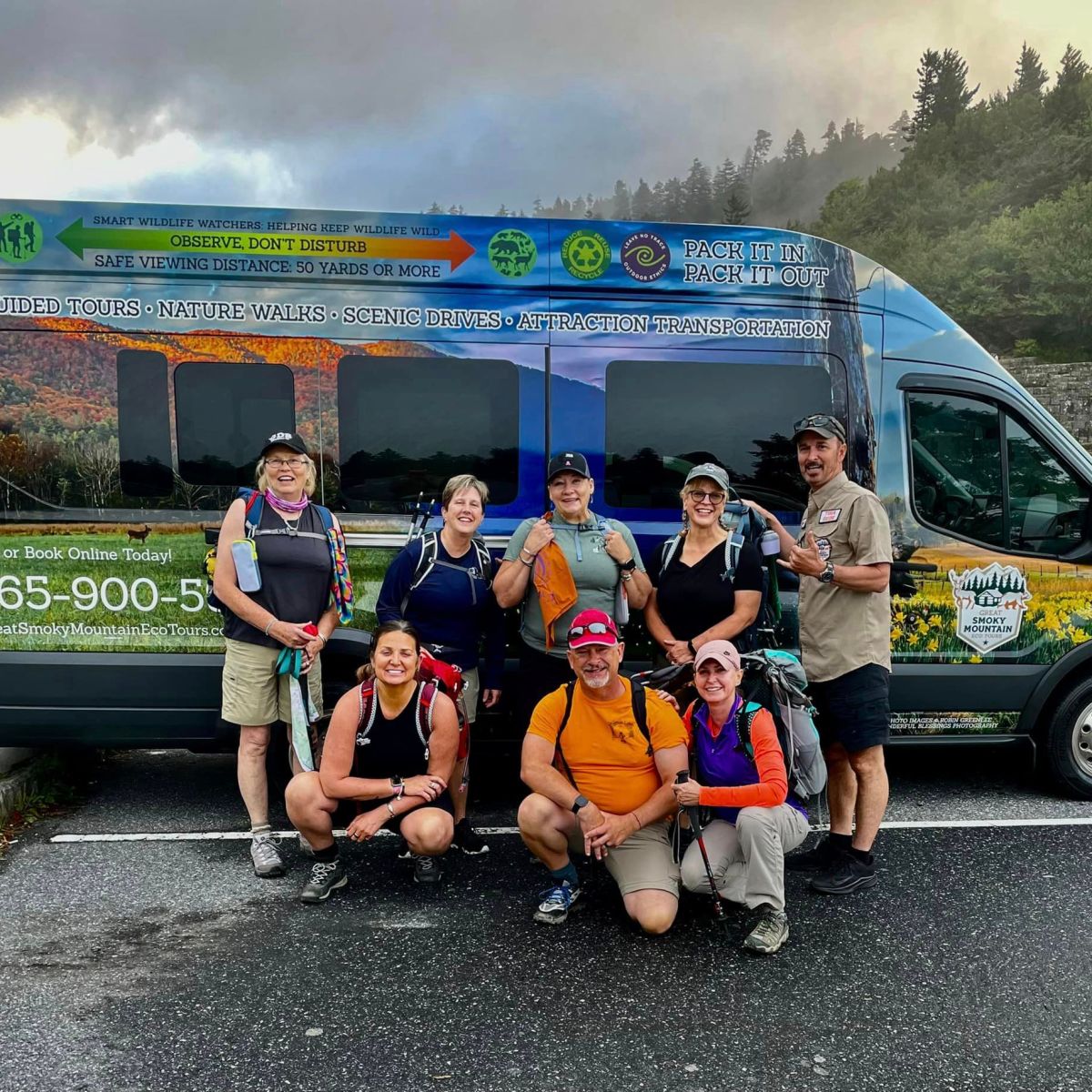 a group of people in a car posing for the camera