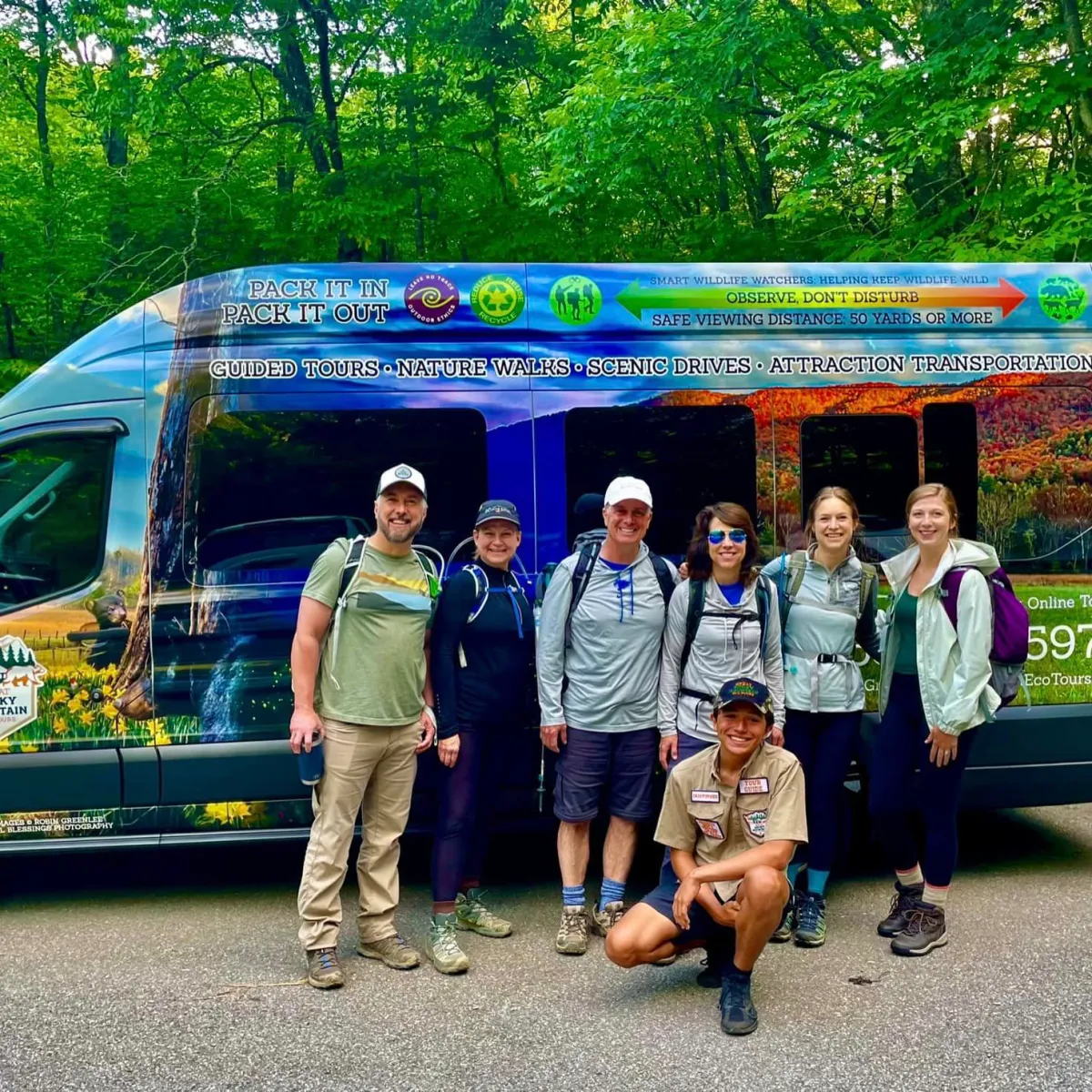 a group of people standing in front of a truck