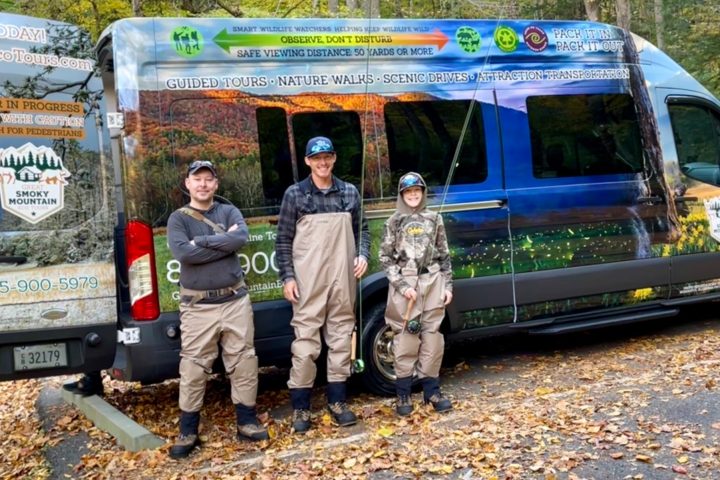 a group of people standing in front of a van