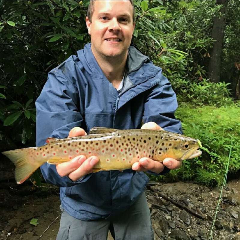 a man holding a fish