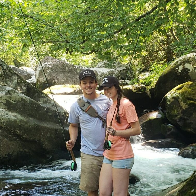 a woman standing next to a river