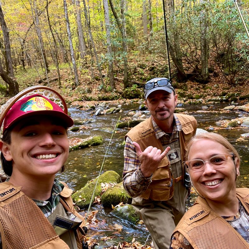 a group of people next to a river