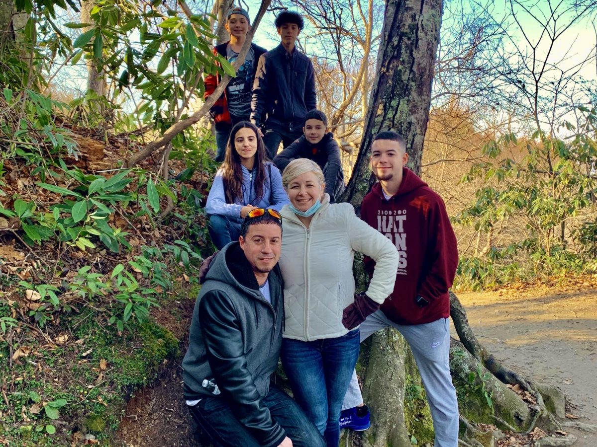 a group of people standing next to a tree