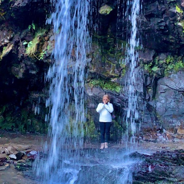 a person riding on the back of a waterfall
