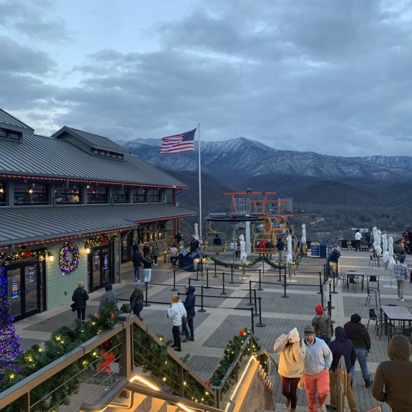 a group of people walking on a bridge