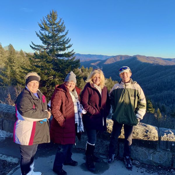 a group of people standing on top of a mountain