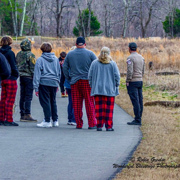 a group of people that are standing in the grass