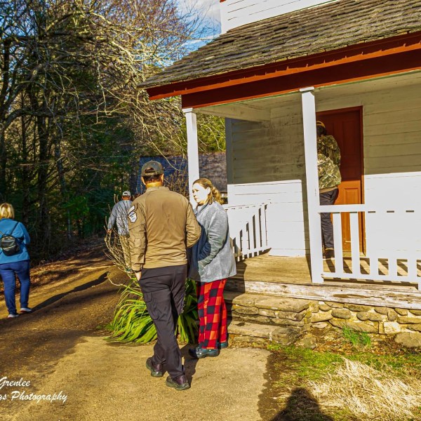 a group of people standing in front of a house