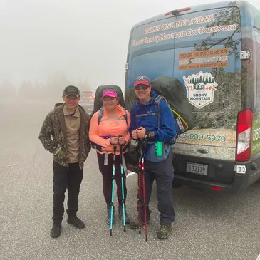 a group of people standing in a parking lot